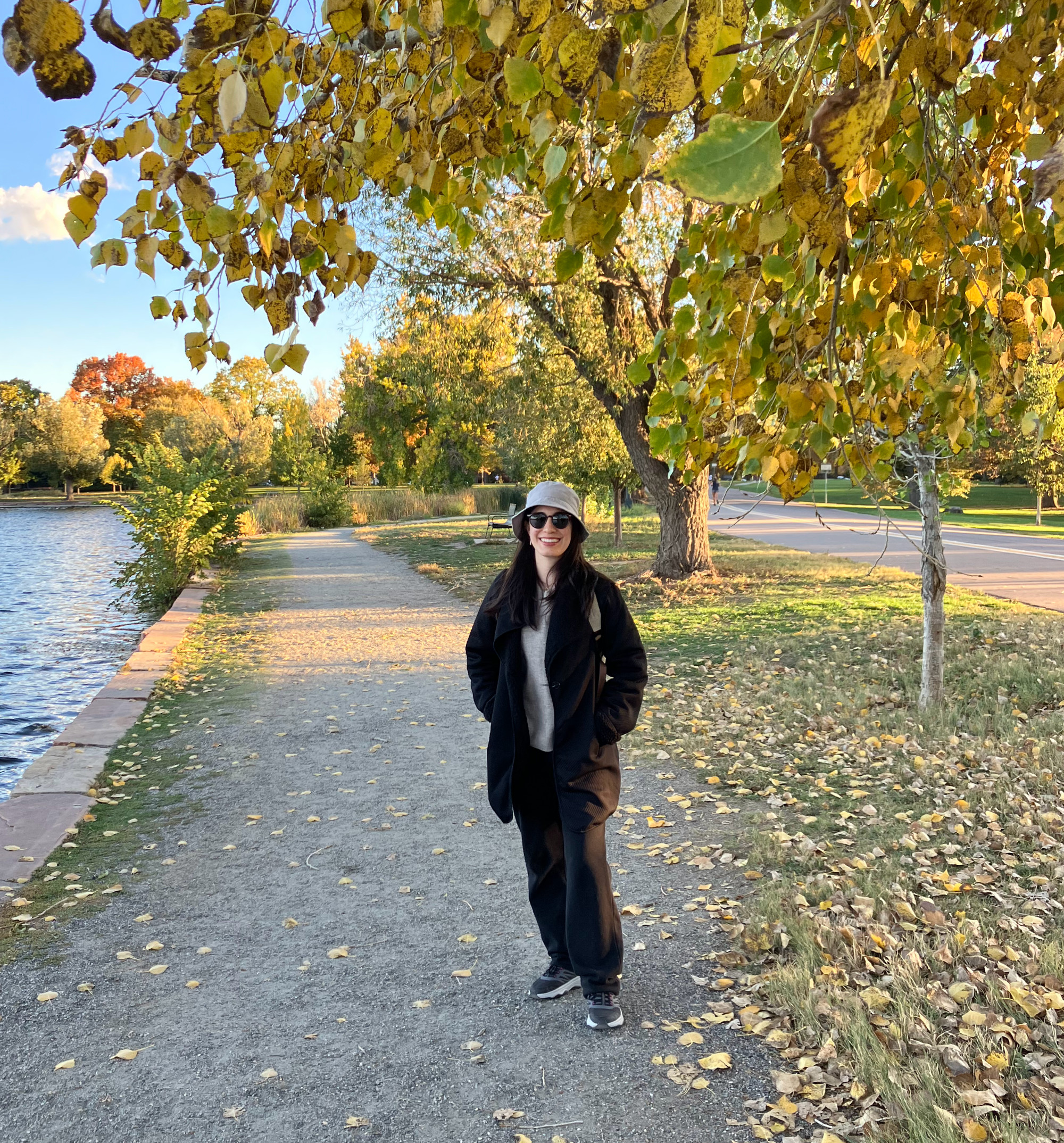 Ruth Kerbawy standing on a lakeside path in autumn.